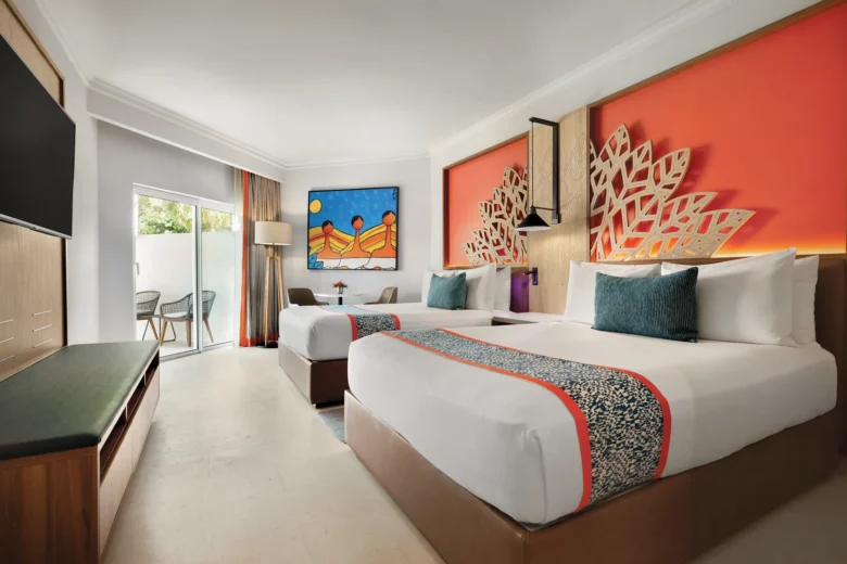 Deluxe Garden View Accessible room with two queen beds and furnished terrace at Dreams La Romana Resort & Spa.