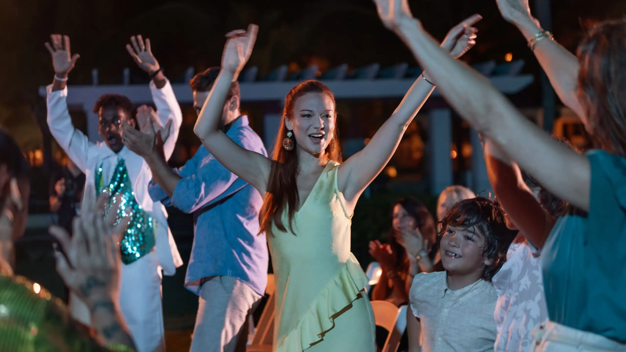 Guests dancing and enjoying live evening entertainment at Dreams La Romana Resort & Spa in the Dominican Republic.