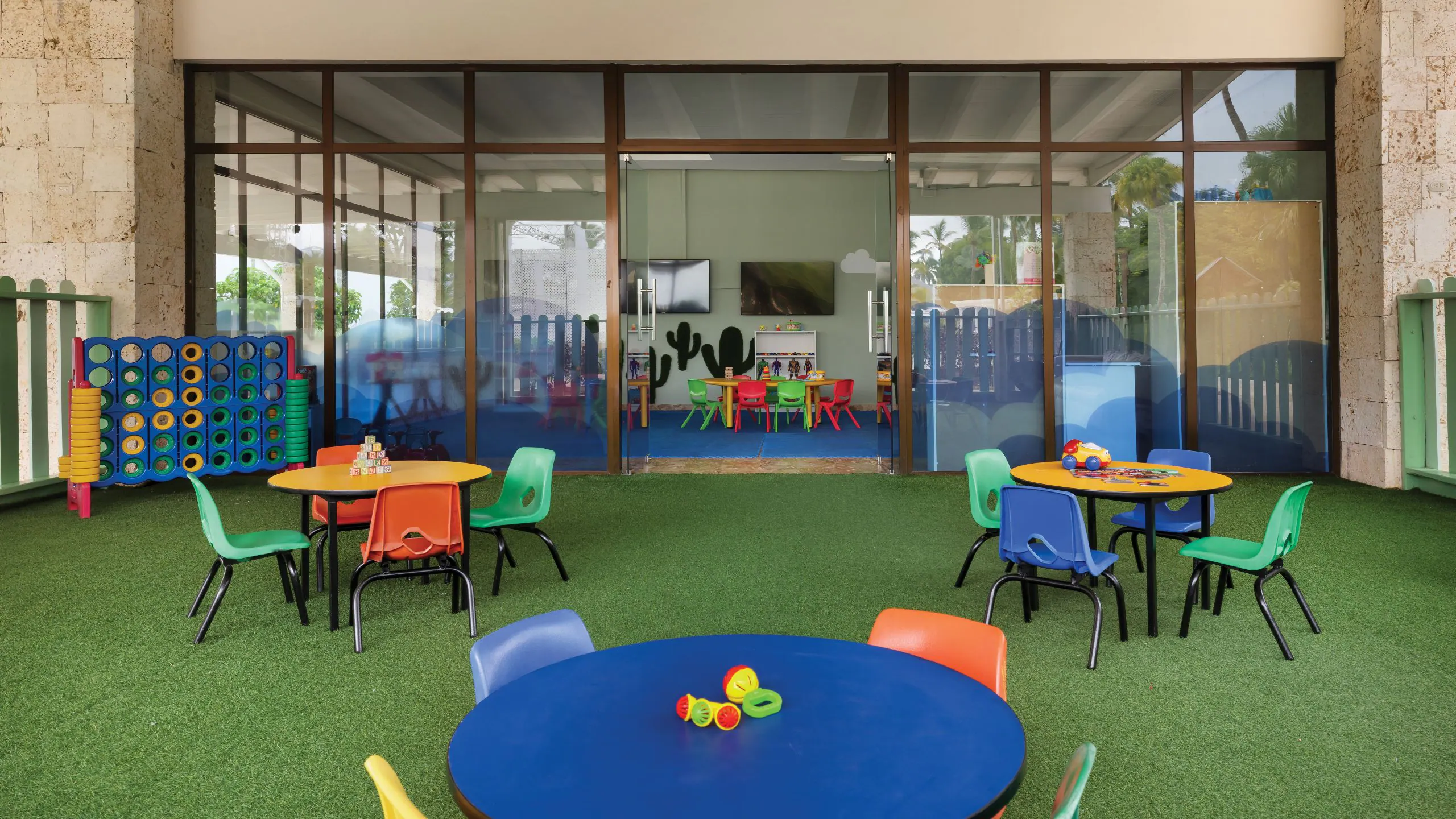 Colorful kids club play area at Dreams La Romana Resort & Spa featuring games, tables, and family-friendly activities.